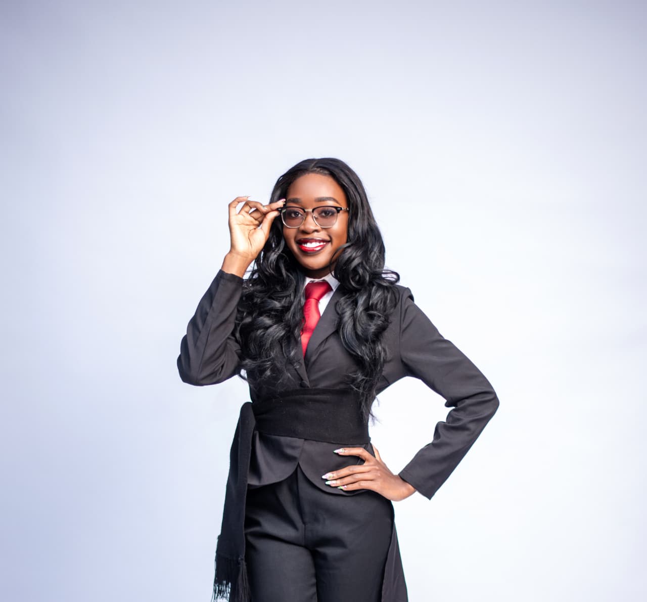 Shania Omollo smiling in formal wear